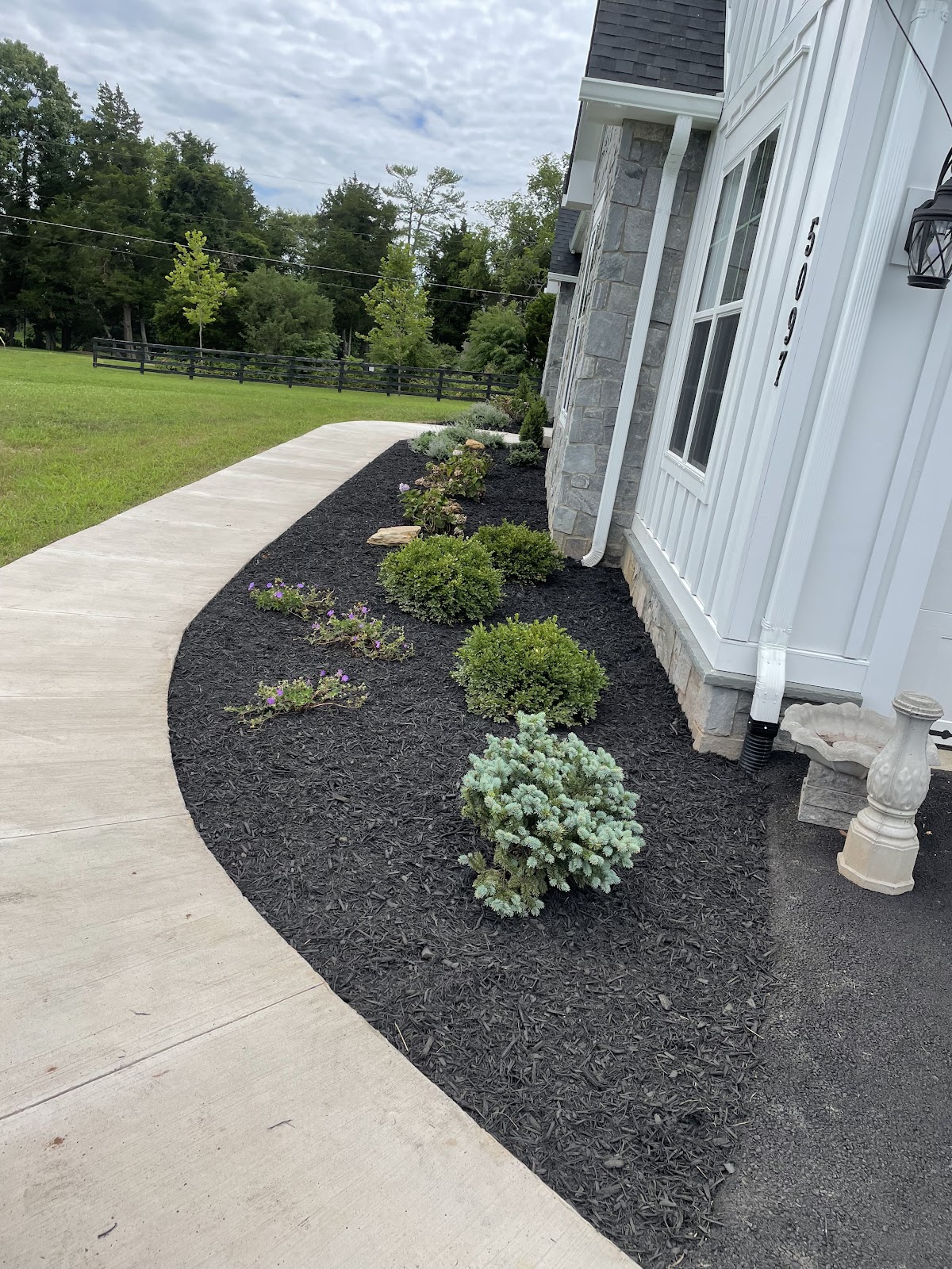 Freshly mulched garden beds and shrubs along a Northern Virginia home