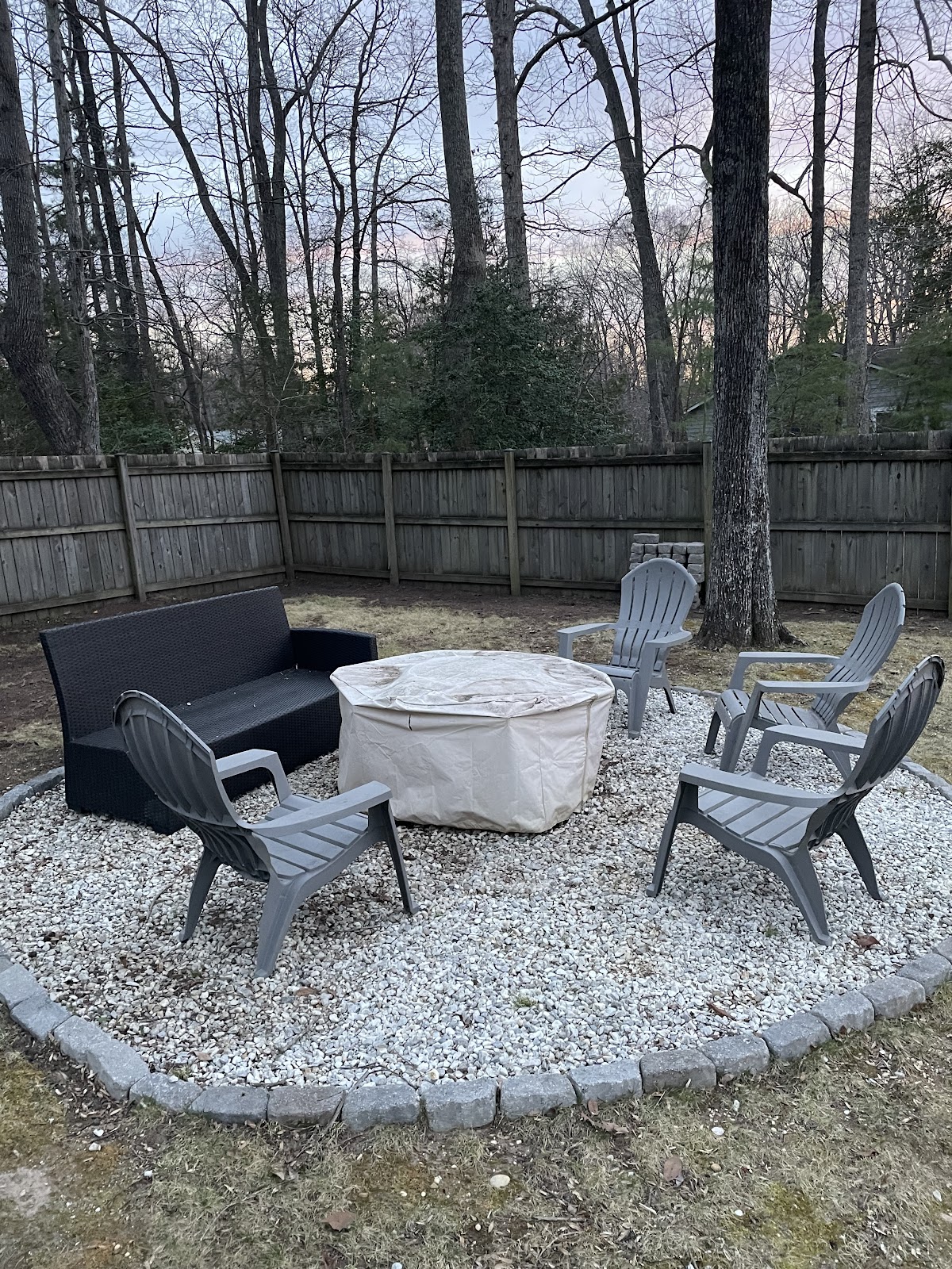 Stone fire-pit lounge with modern chairs